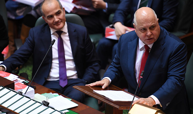Victorian Treasurer Tim Pallas (right) delivers his budget speech in the Legislative Assembly at Victorian State Parliament in Melbourne. (AAP Image/James Ross)