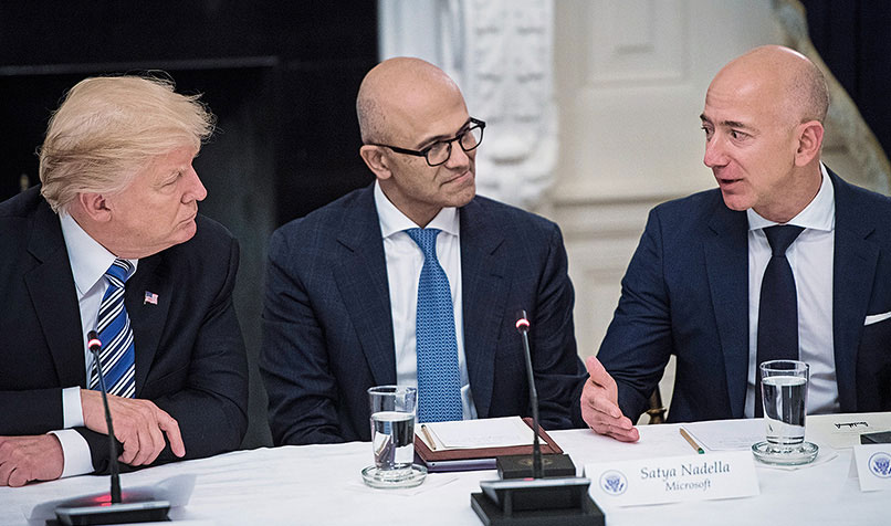 President Donald Trump is joined by Amazon founder Jeff Bezos and Microsoft CEO Satya Nadella at the American Technology Council roundtable at the Whitehouse.