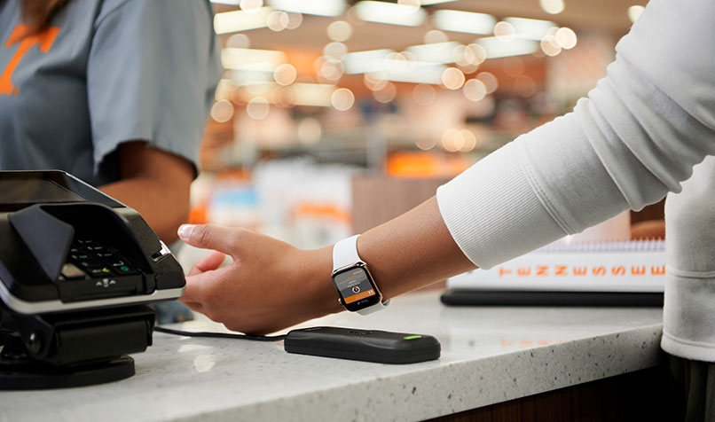 A customer uses an Apple watch to make a payment.