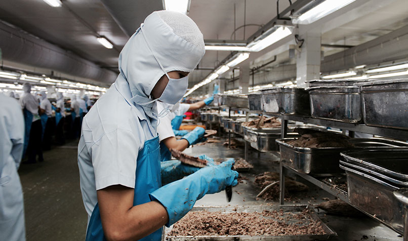 A worker in a production line at a seafood processing operation in Bangkok, Thailand, in April 2020.