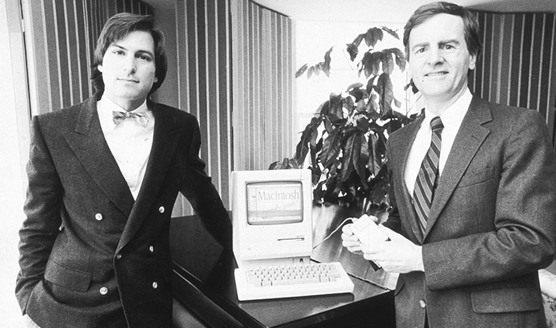 The late Steve Jobs (L), chairman of Apple Computers, and John Sculley, Apple’s former president, pose with the original Macintosh personal computer, in January 1984.