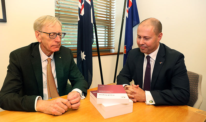 Commissioner Kenneth Hayne and Treasurer Josh Frydenberg (R) with the final report from the Royal Commission into Misconduct in the Banking, Superannuation and Financial Services Industry, in February 2019.