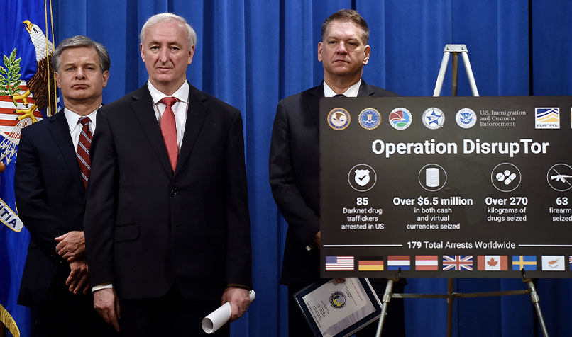US Deputy Attorney General Jeffrey Rosen (C), FBI Director Christopher Wray (L) and Drug Enforcement Agency acting Administrator Timothy Shea (R) attend a news conference reporting the arrest of 179 people and the seizing of more than US$6.5 million (A$8.7 million) in a worldwide crackdown on opioid trafficking on the dark web.
