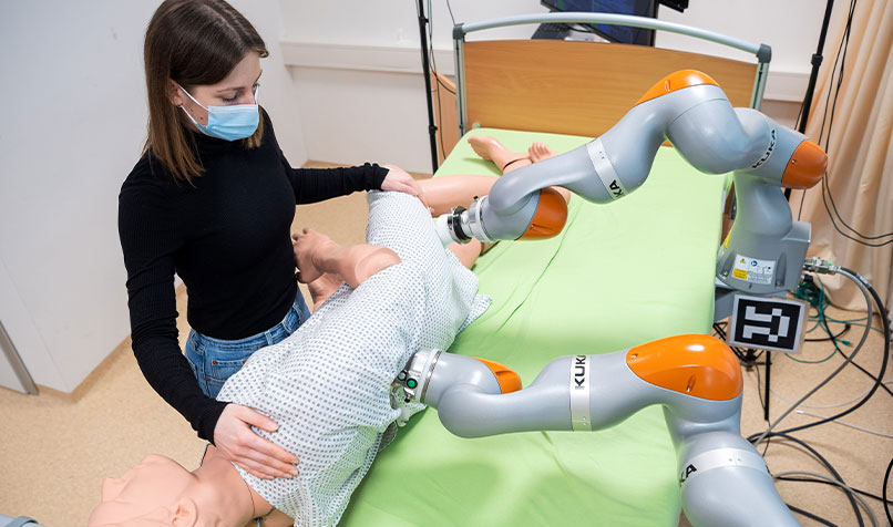 Robotic arms help a research assistant move a doll during an experimental set-up at Carl von Ossietzky University of Oldenburg in Germany.